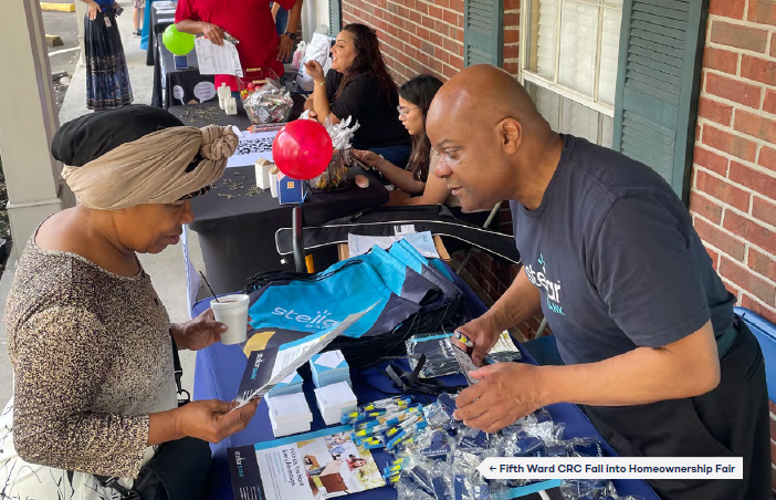 A man helping a woman learn about home mortgages.