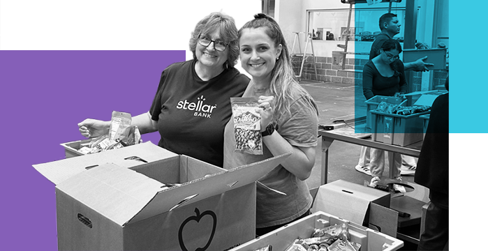 Two female Stellar Bank volunteers counting donated food