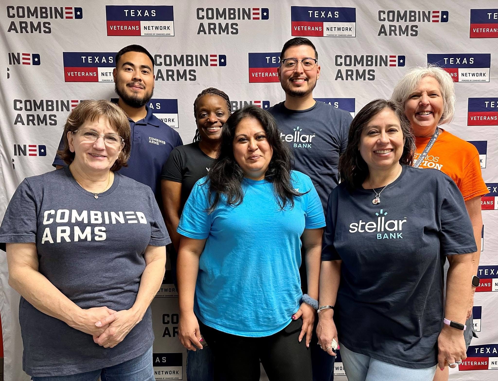 Stellar Bank employees standing with members of the American Heart Association at a volunteer event